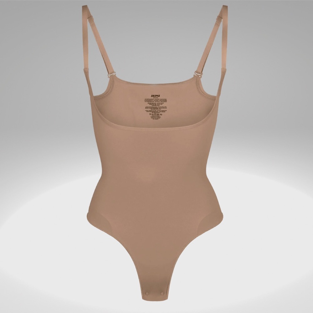 NTW Skims Seamless Sculpt Open Bust Thong Bodysuit in the Sienna color.